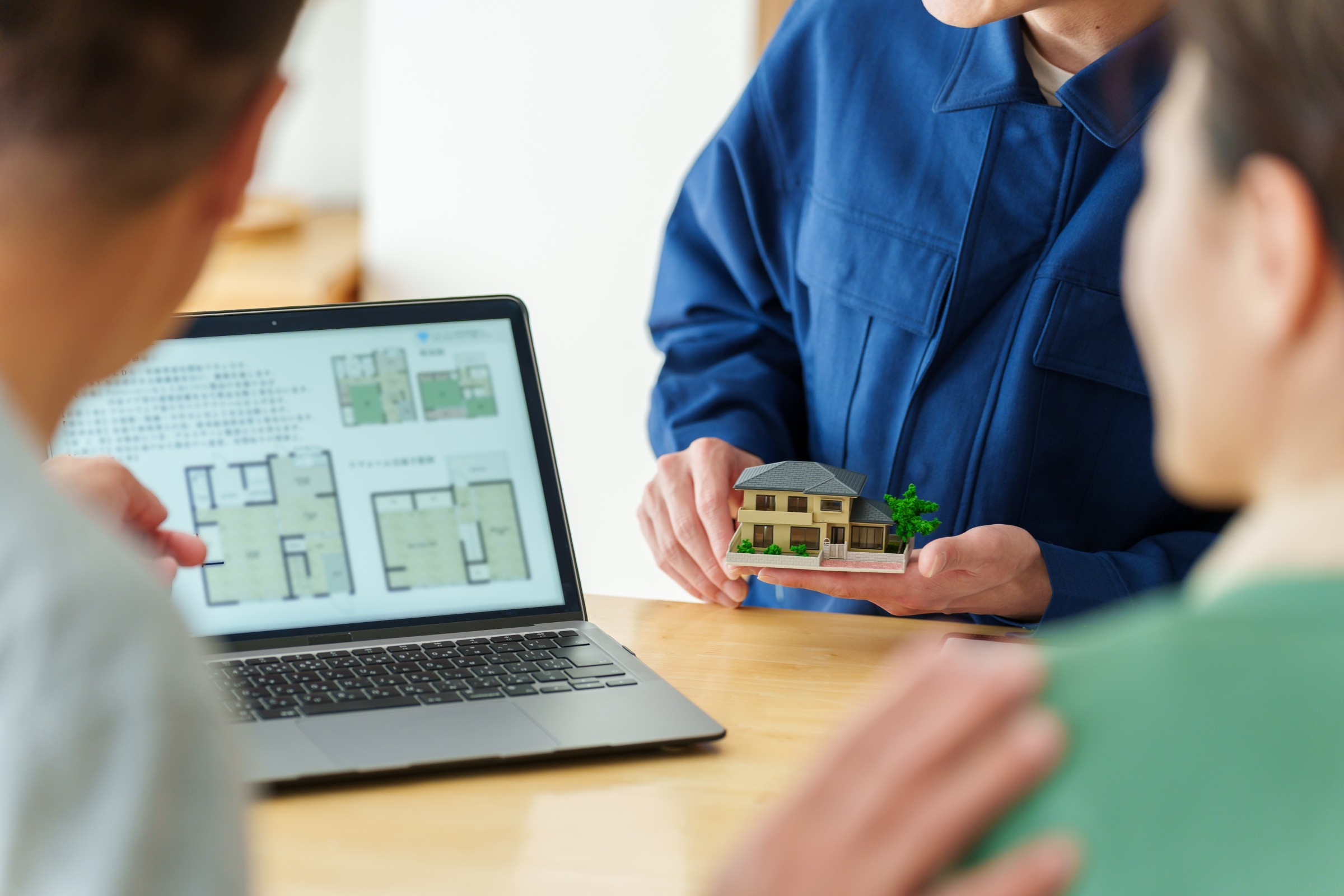 คู่รักกำลังคุยกับเจ้าหน้าที่ ทำเรื่องยื่นขอสินเชื่อต่อเติมบ้าน (1)